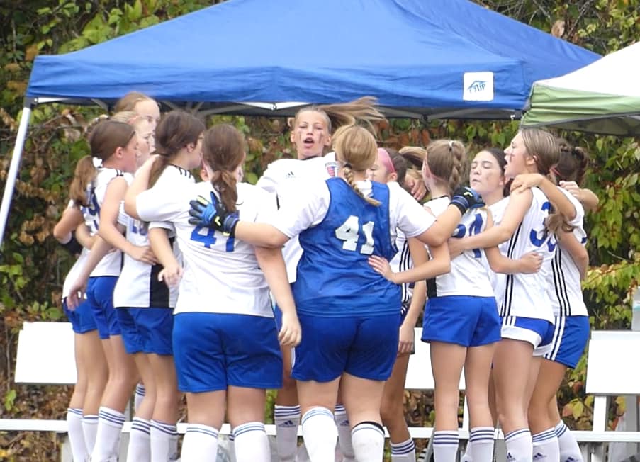 HNFC travel team layers in a huddle