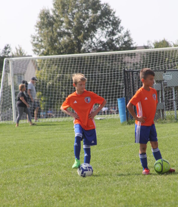 HNFC Rec Plus boys soccer players practicing on the field